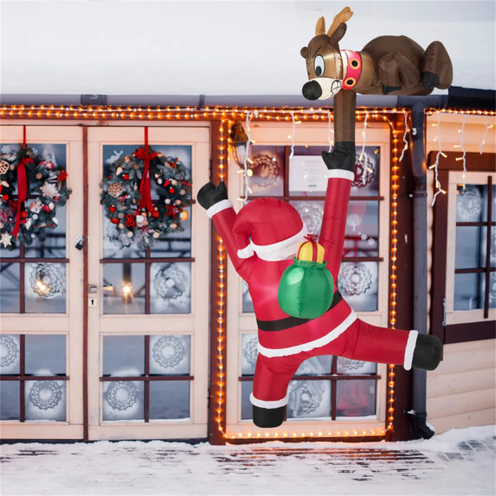 Inflatable climbing Santa and reindeer glowing outdoors