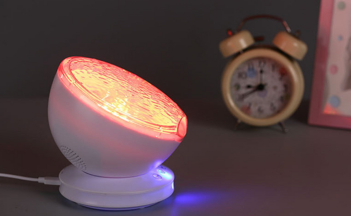 Ocean wave projector lighting a bedroom