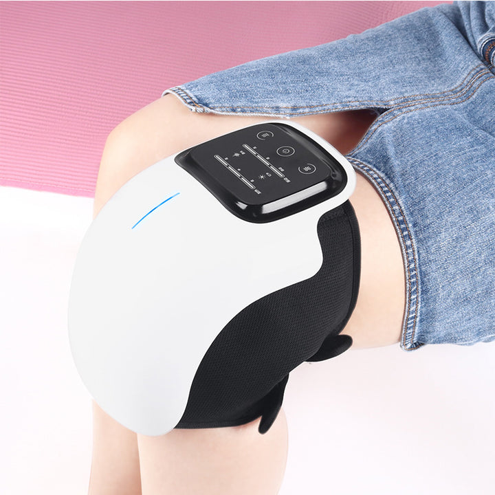 White wearable knee massager wrapped around a knee