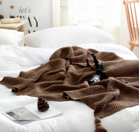 Waffle knit throw with pom-pom fringe