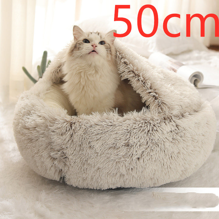 Cat curled up in a round plush bed with hood
