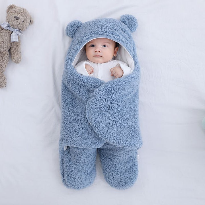 Baby in a plush bear-ear hooded wrap