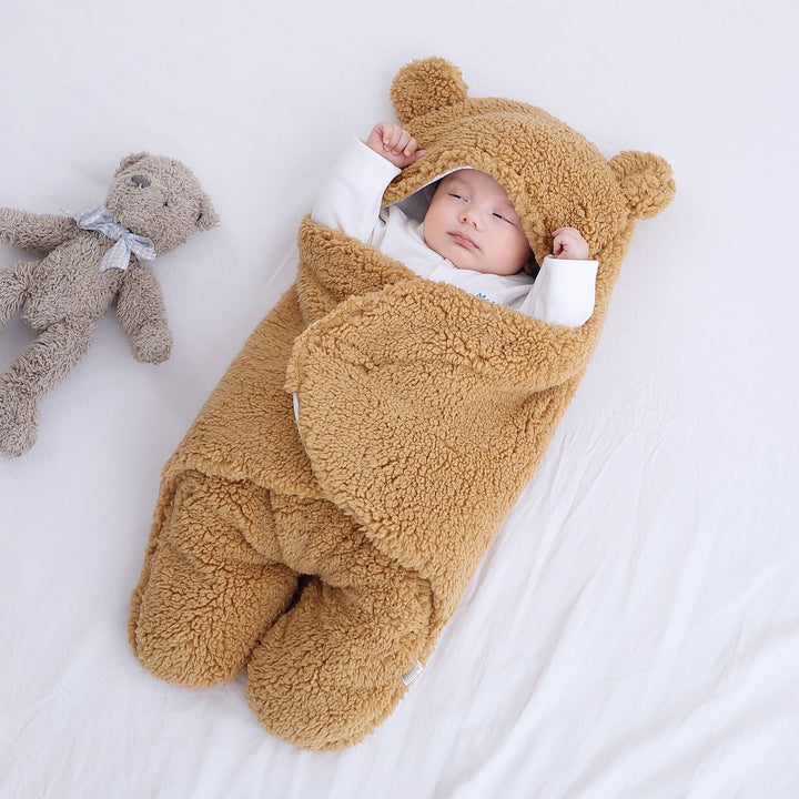 Baby in a plush bear-ear hooded wrap