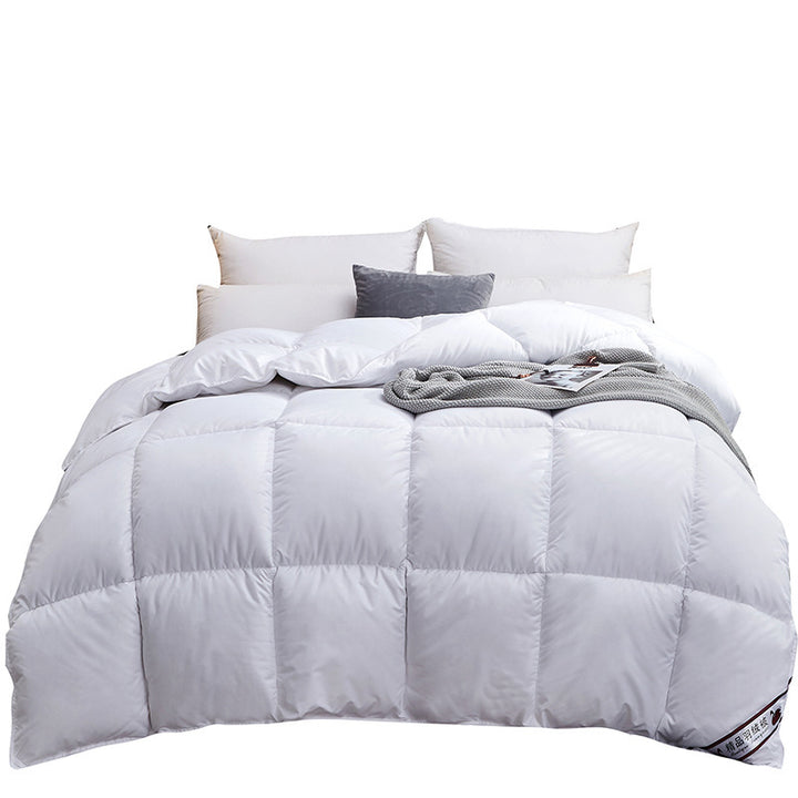 Quilted winter comforter on a made bed