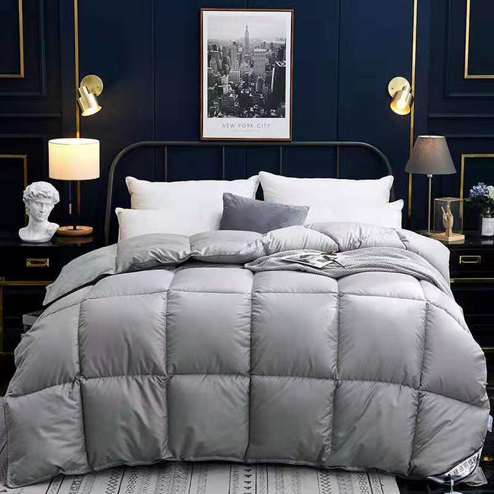 Quilted winter comforter on a made bed