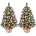 Two frosted tabletop trees with lights