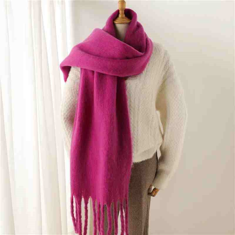 Woman wearing a fluffy mustard scarf