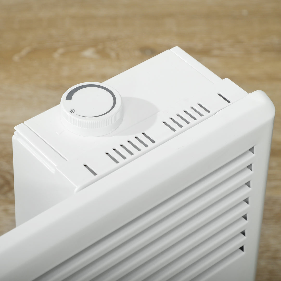 White freestanding convection heater on a wood floor