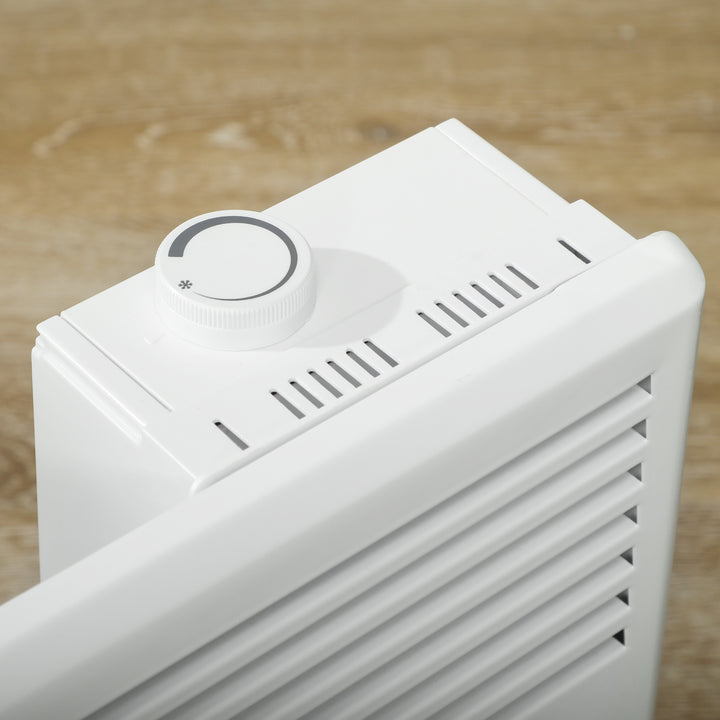 White freestanding convection heater on a wood floor