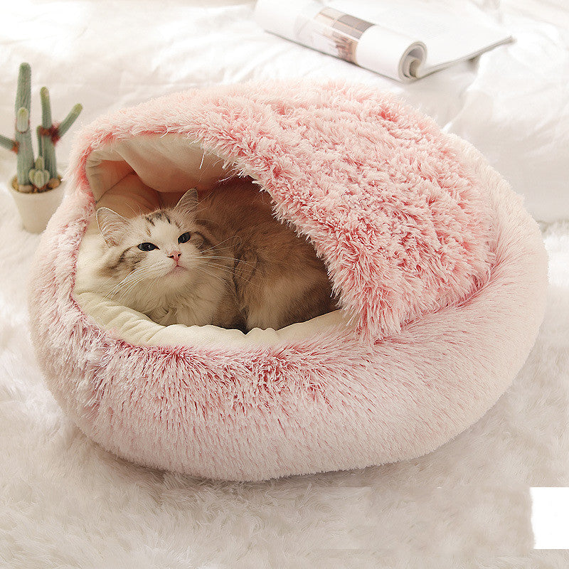 Cat curled up in a round plush bed with hood