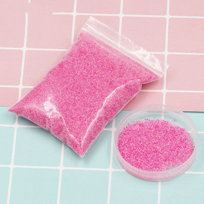 Colorful magic sand in water