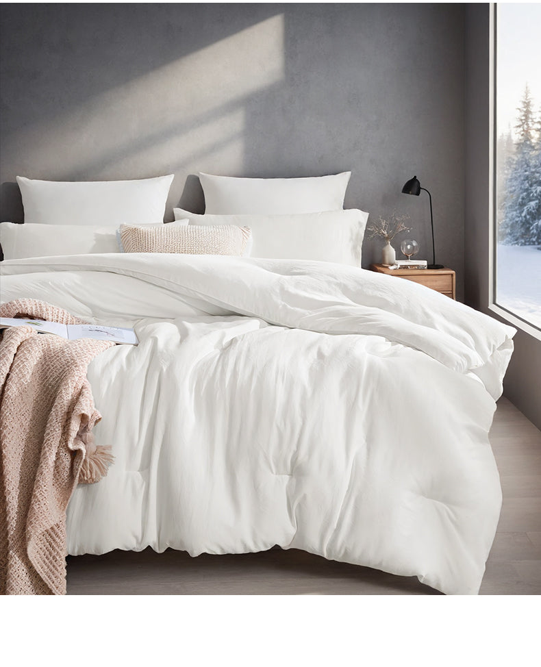 White box stitched comforter on a bed