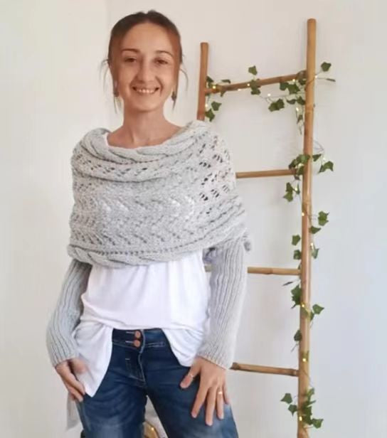 Woman wearing a knit shawl with sleeves