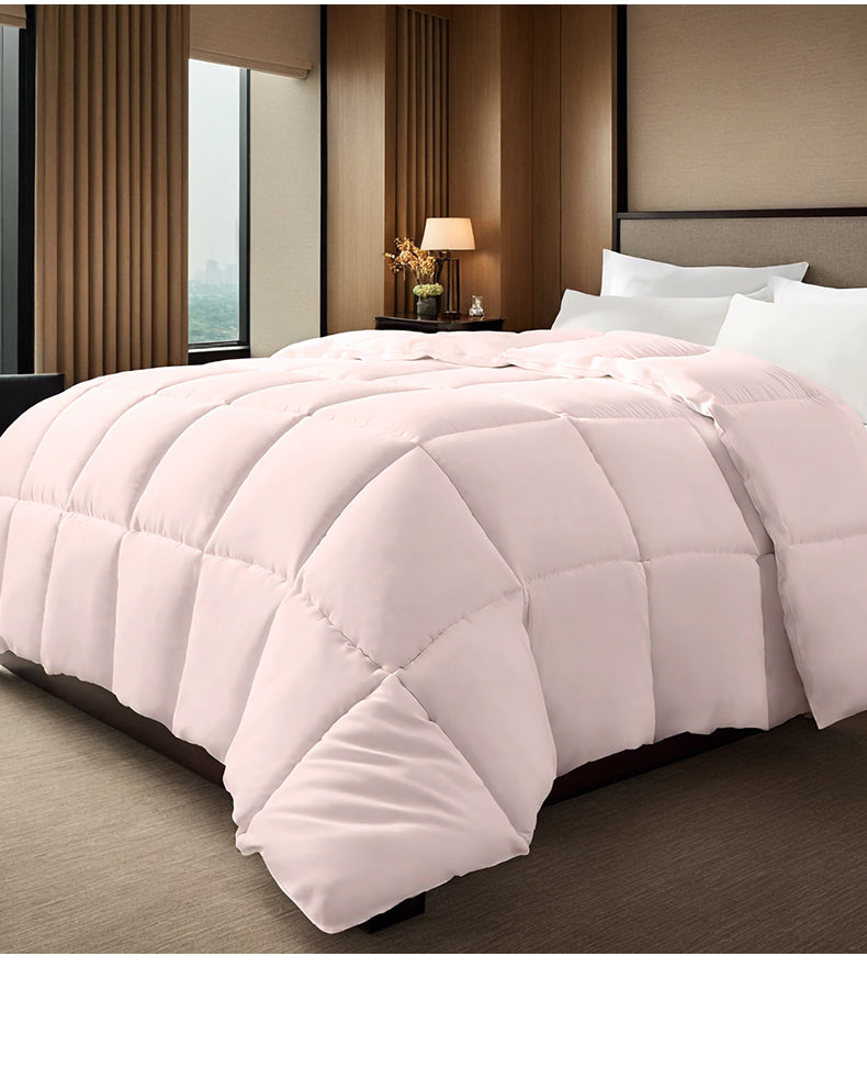 Pink box stitched comforter on a bed