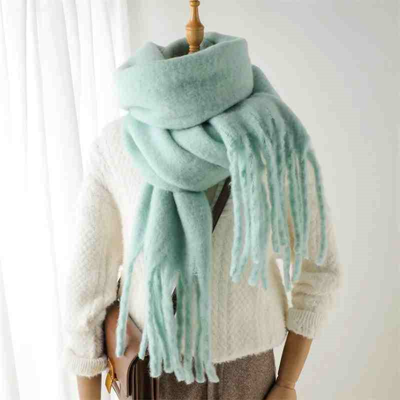 Woman wearing a fluffy mustard scarf