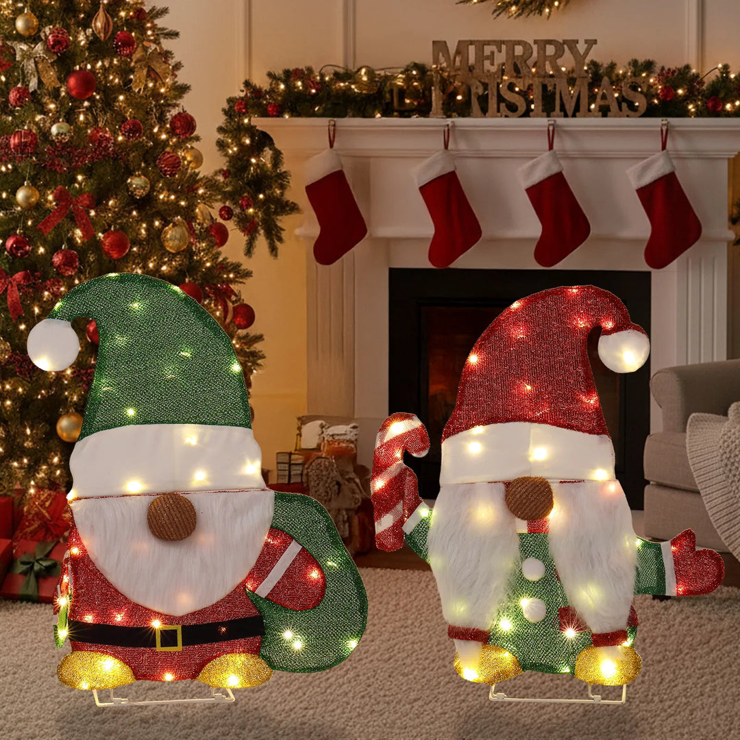 Two lighted Christmas gnomes in a yard