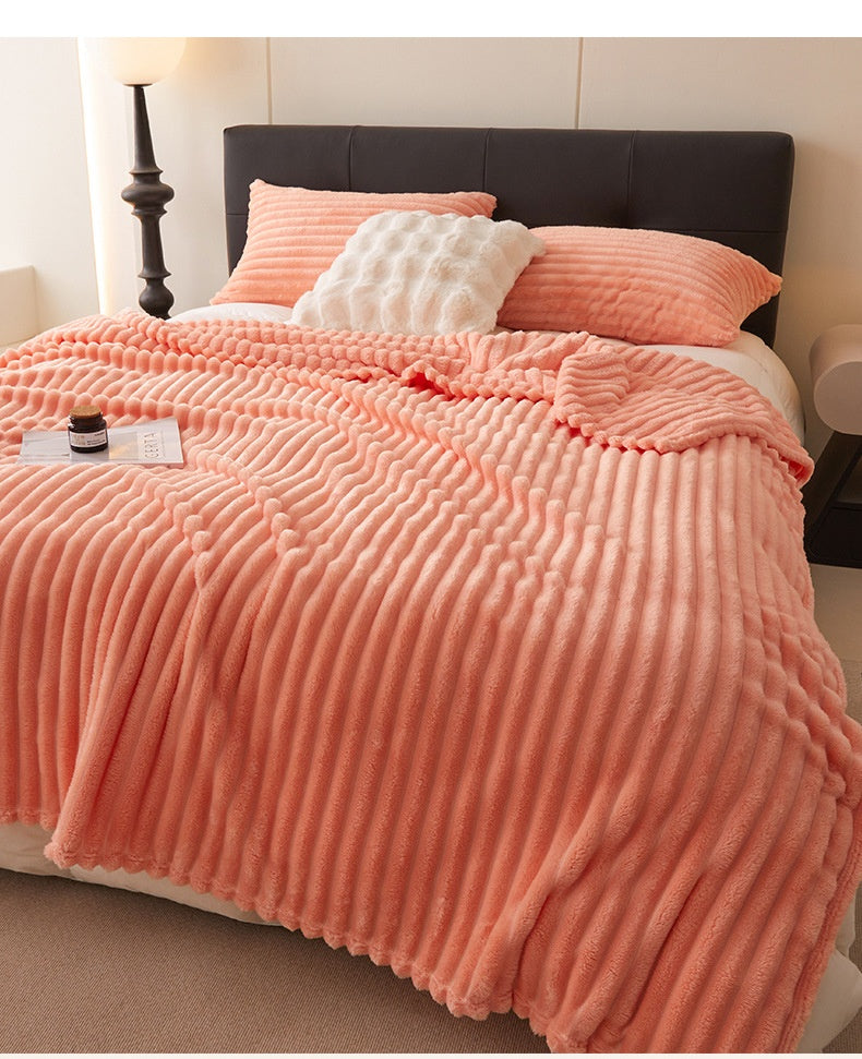 Ribbed faux rabbit fur blanket on bed