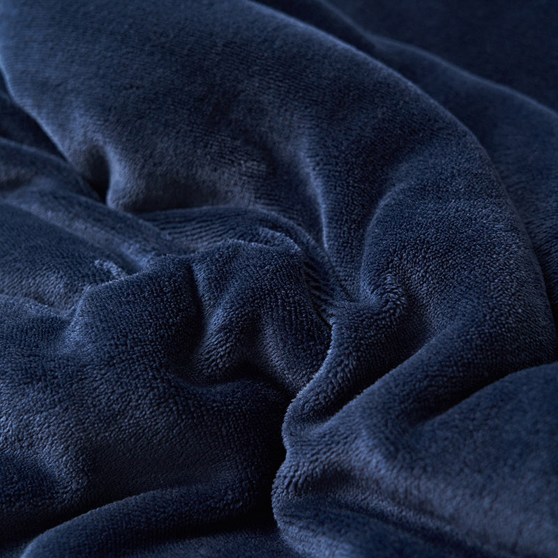 Reversible sherpa throw on a bed