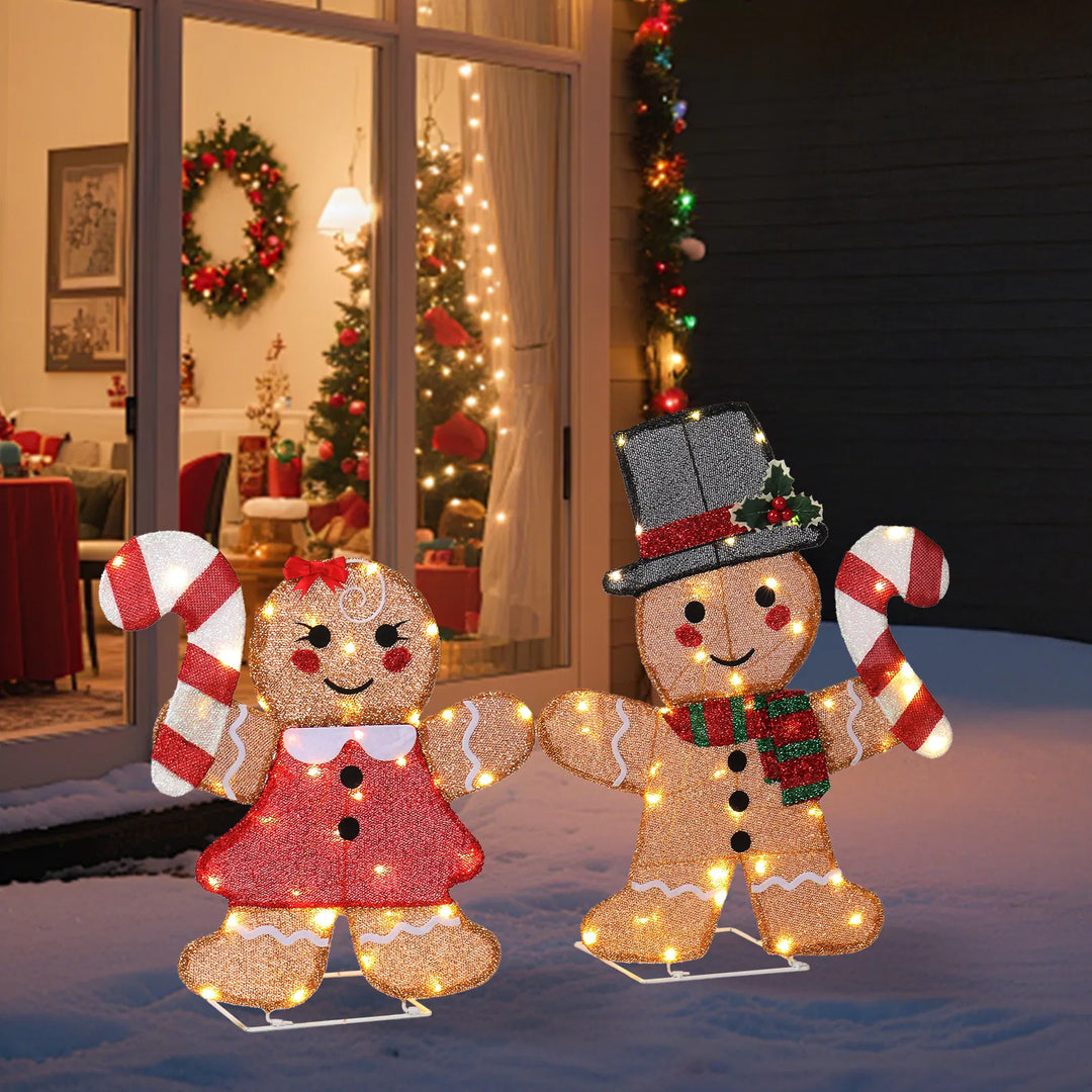 Two lighted gingerbread figures with candy canes