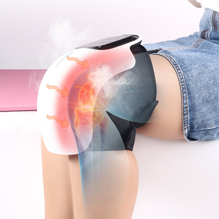White wearable knee massager wrapped around a knee