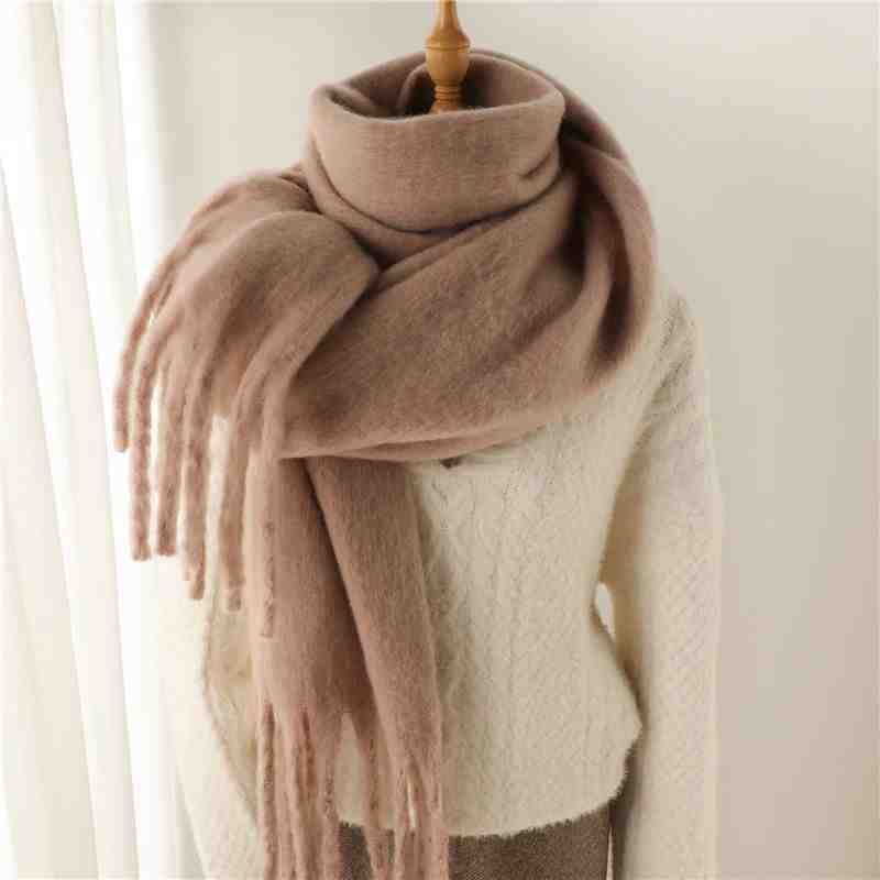 Woman wearing a fluffy mustard scarf