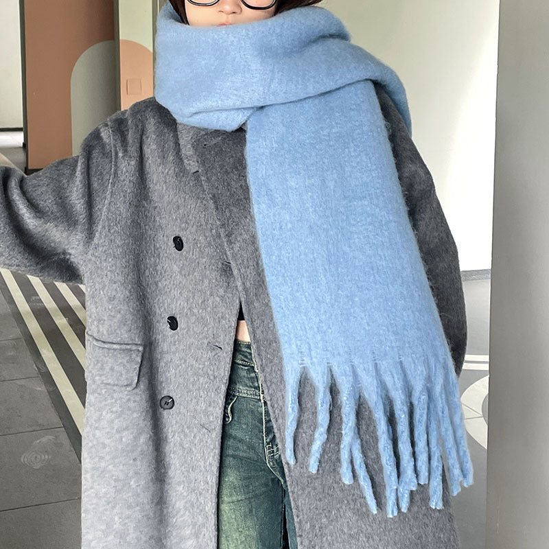 Woman wrapped in a fluffy oversized scarf