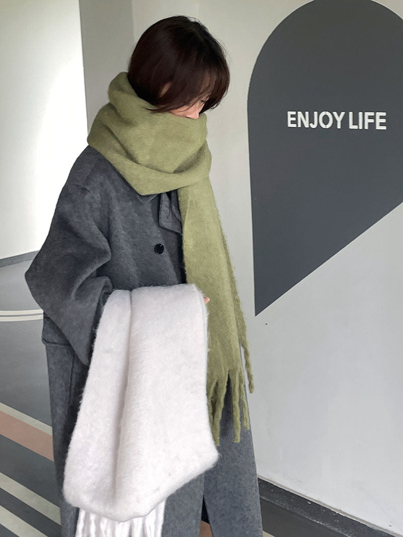Woman wrapped in a fluffy oversized scarf