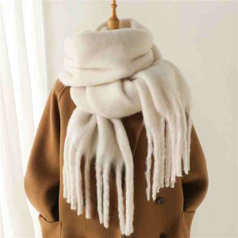 Woman wearing a fluffy mustard scarf