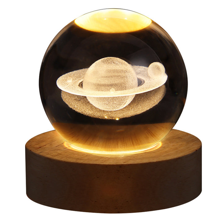 Glowing crystal ball with Saturn engraving