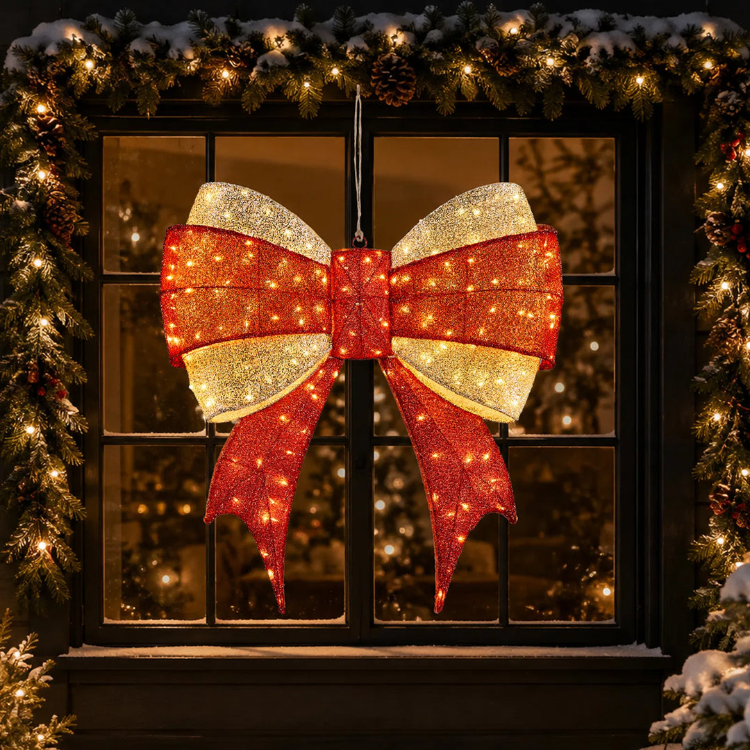 Large lighted red and gold Christmas bow