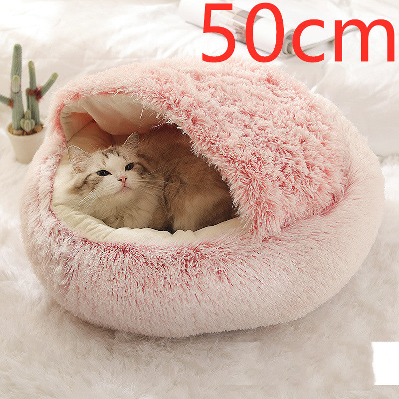 Cat curled up in a round plush bed with hood