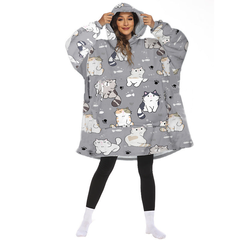 Person wearing oversized hooded blanket