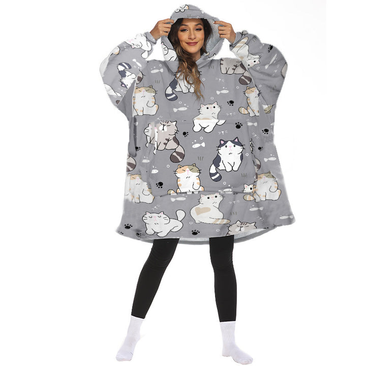 Person wearing oversized hooded blanket