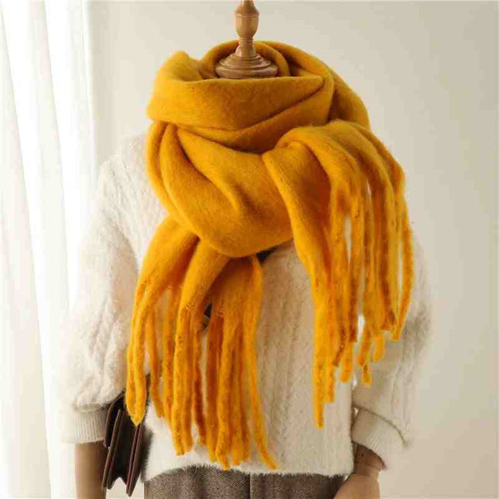 Woman wearing a fluffy mustard scarf