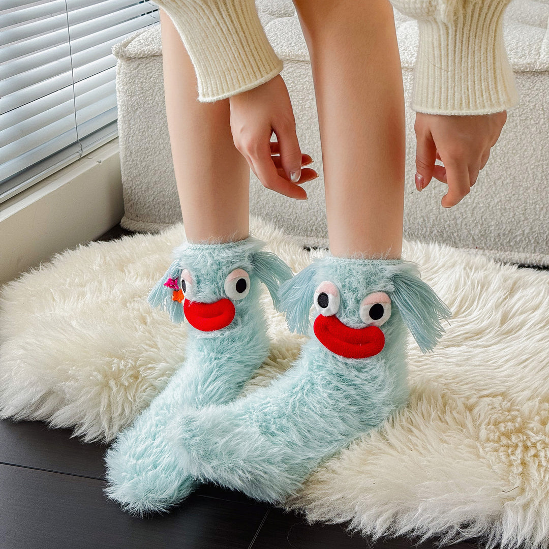 Fluffy green plush socks with googly-eyed monster faces