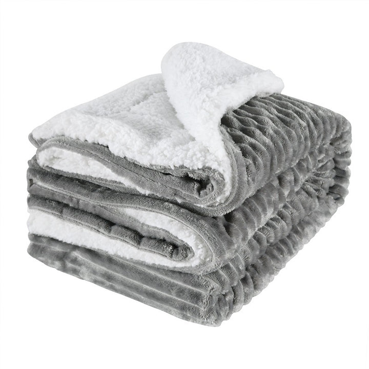 Thick sherpa fleece throw on a sofa