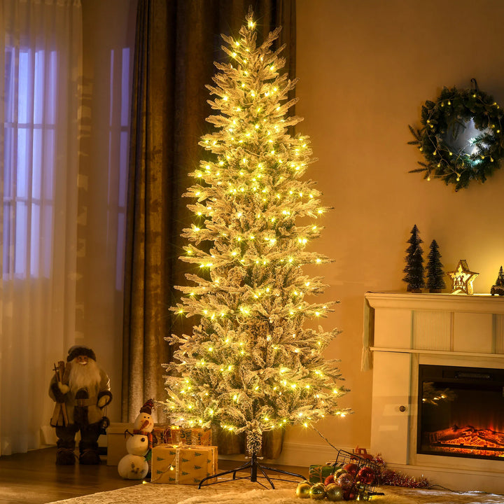 Tall snow flocked Christmas tree with lights