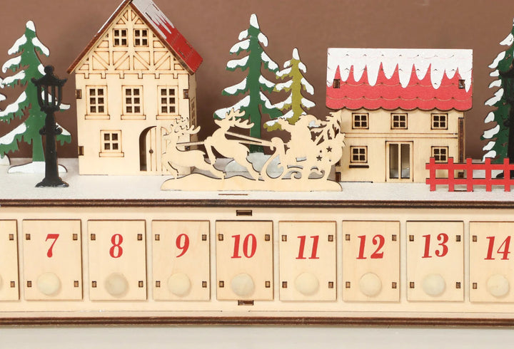 Long lighted wooden advent calendar on mantel