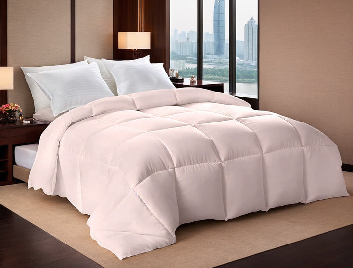 Pink box stitched comforter on a bed