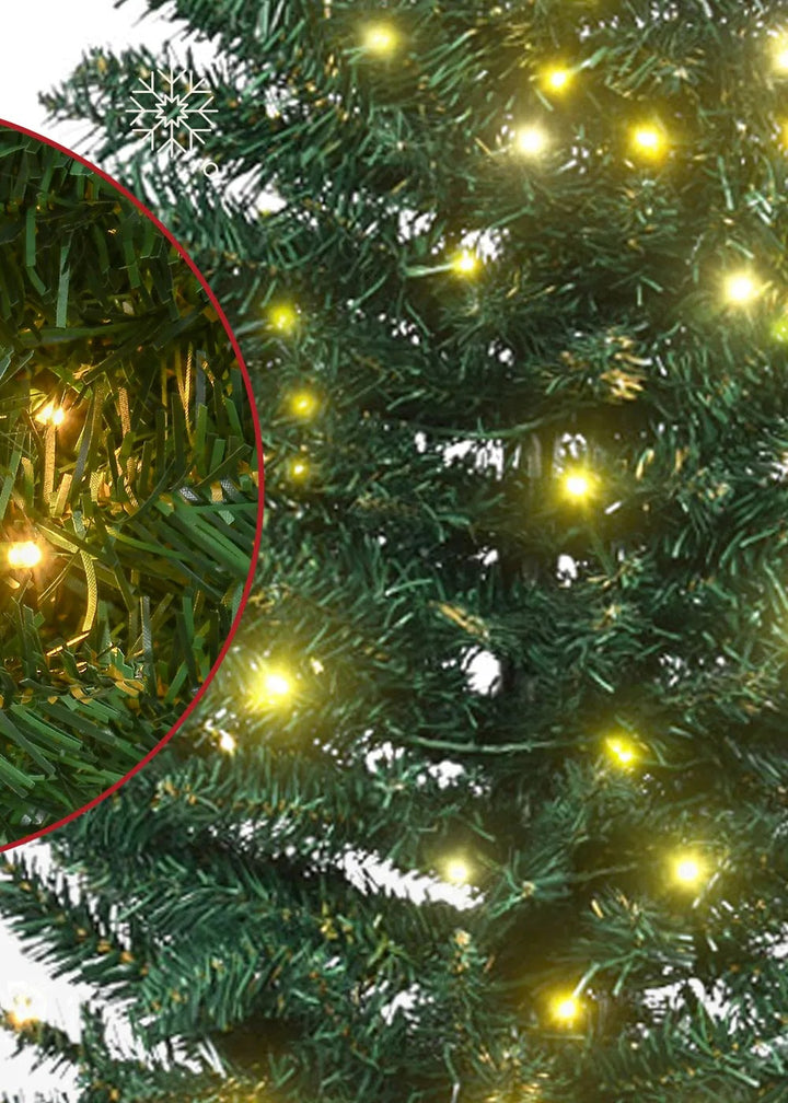 Slim pre-lit green pencil Christmas tree glowing