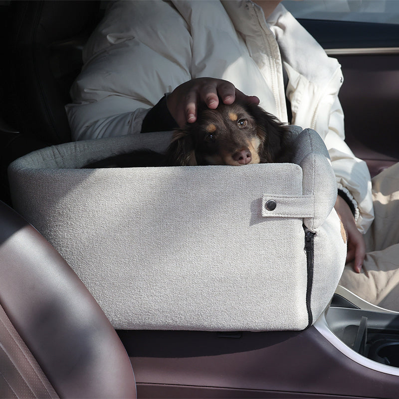 Small dog in armrest car seat bed