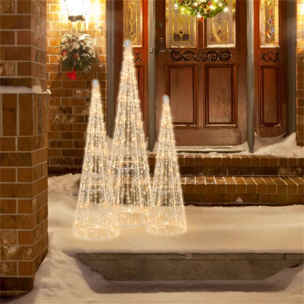 Three lighted cone Christmas trees outdoors