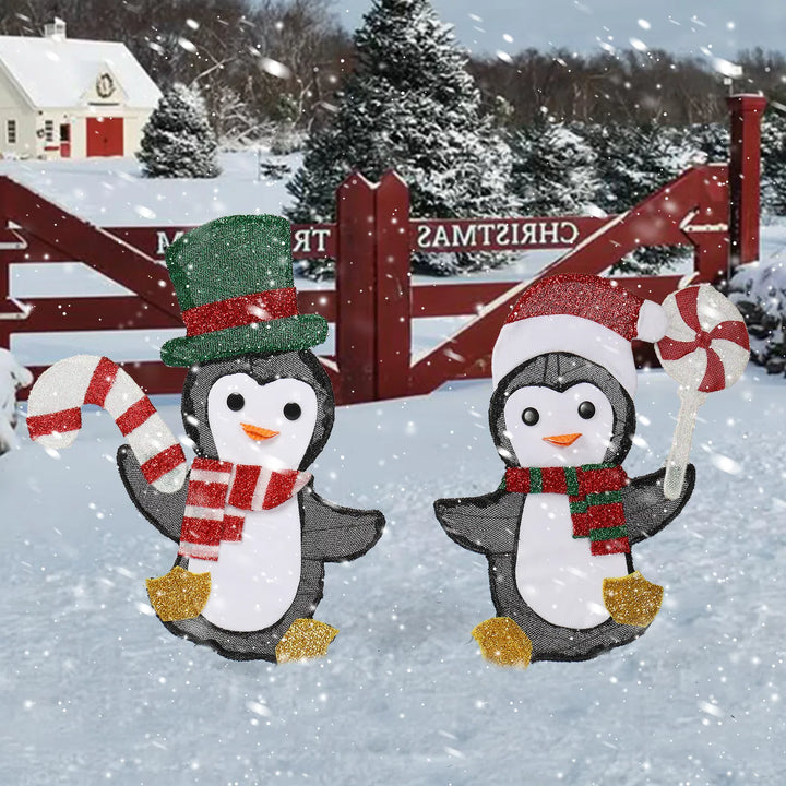 Two lighted penguins with candy canes