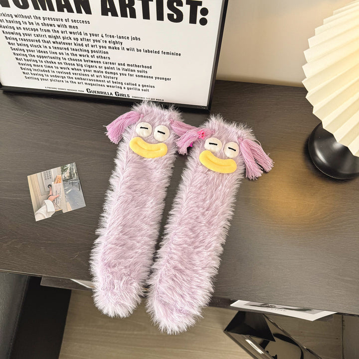 Fluffy green plush socks with googly-eyed monster faces