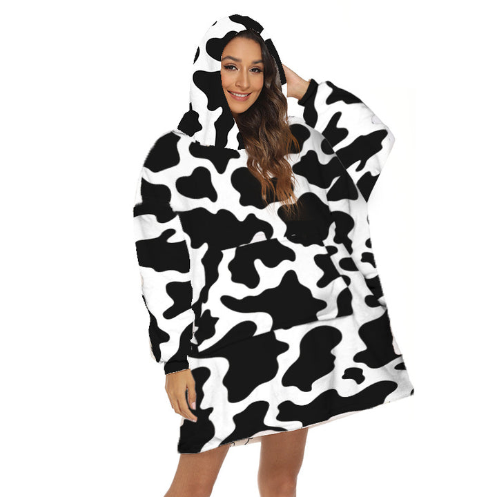 Person wearing oversized hooded blanket