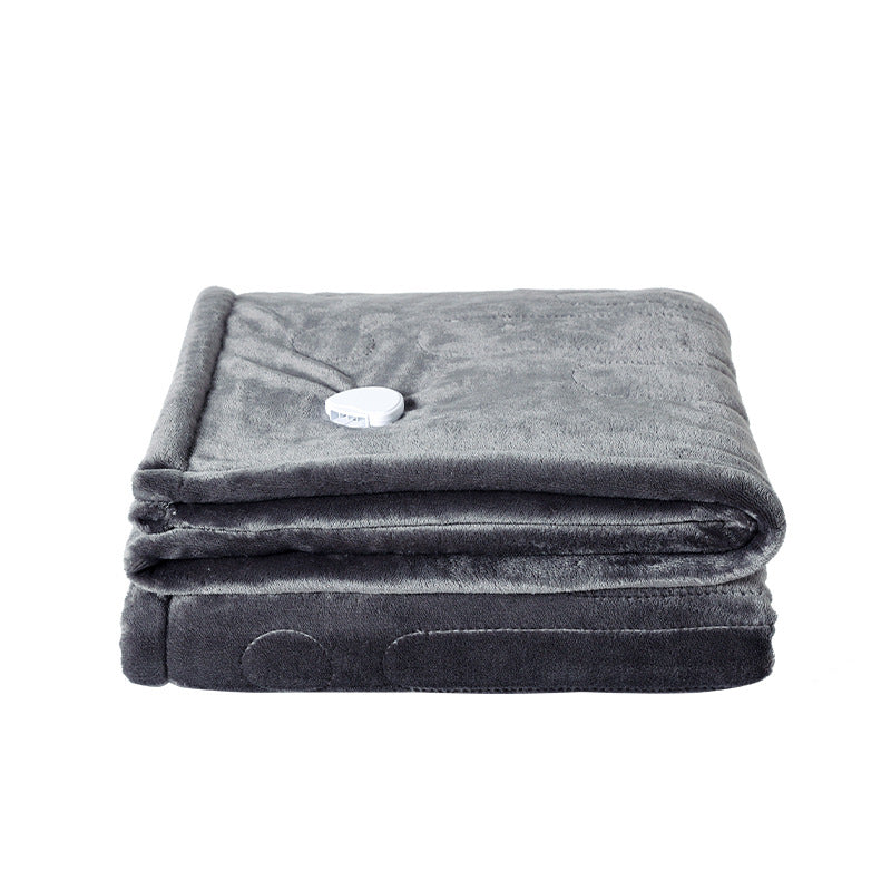 Electric heated flannel throw blanket on sofa