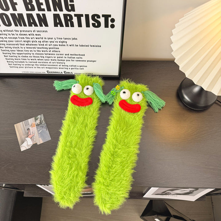 Fluffy green plush socks with googly-eyed monster faces