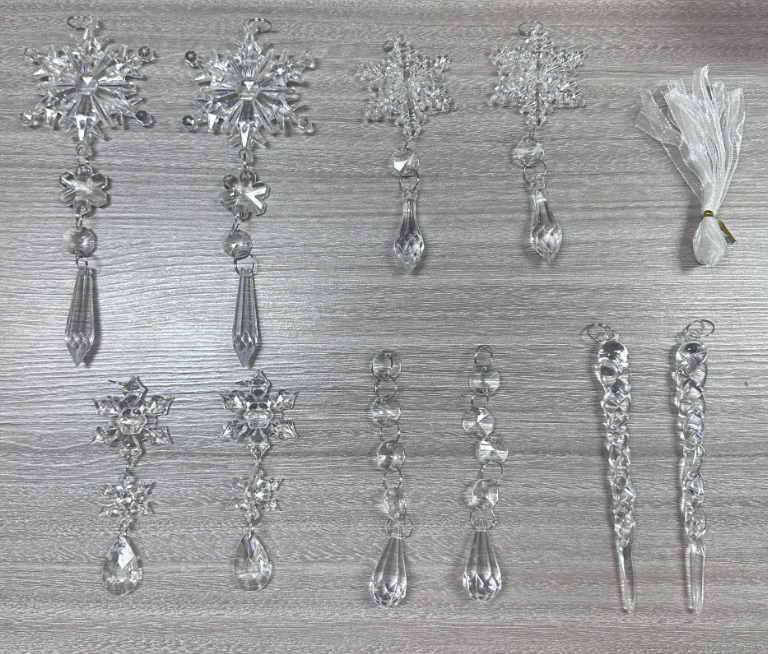 Clear acrylic icicle ornaments hanging on a Christmas tree