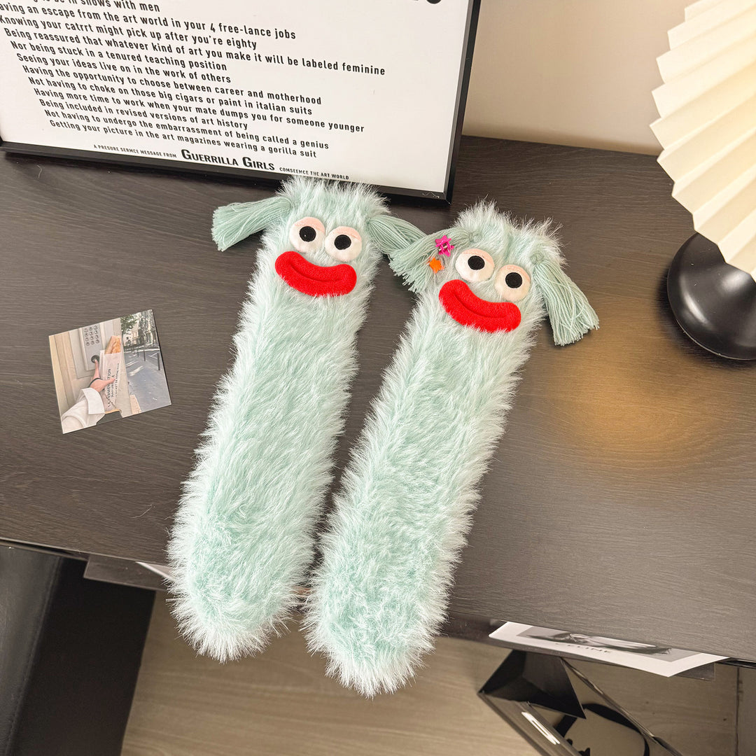 Fluffy green plush socks with googly-eyed monster faces